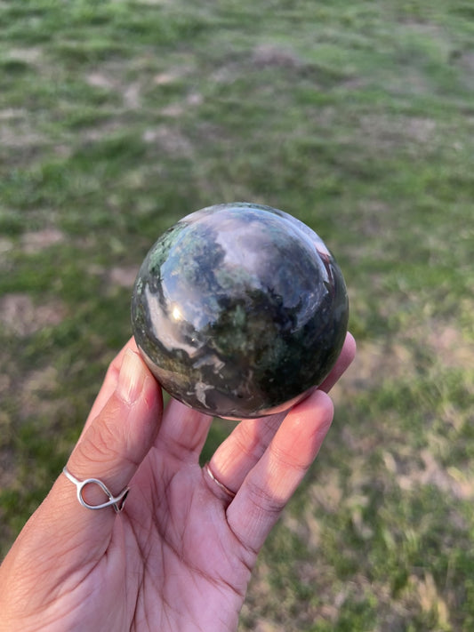 Dark and moody moss agate sphere with natural green inclusions